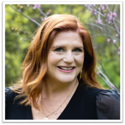 A person smiling at the camera
Description automatically generated